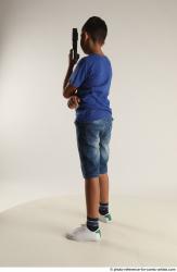 TIMBO STANDING POSE WITH GUN